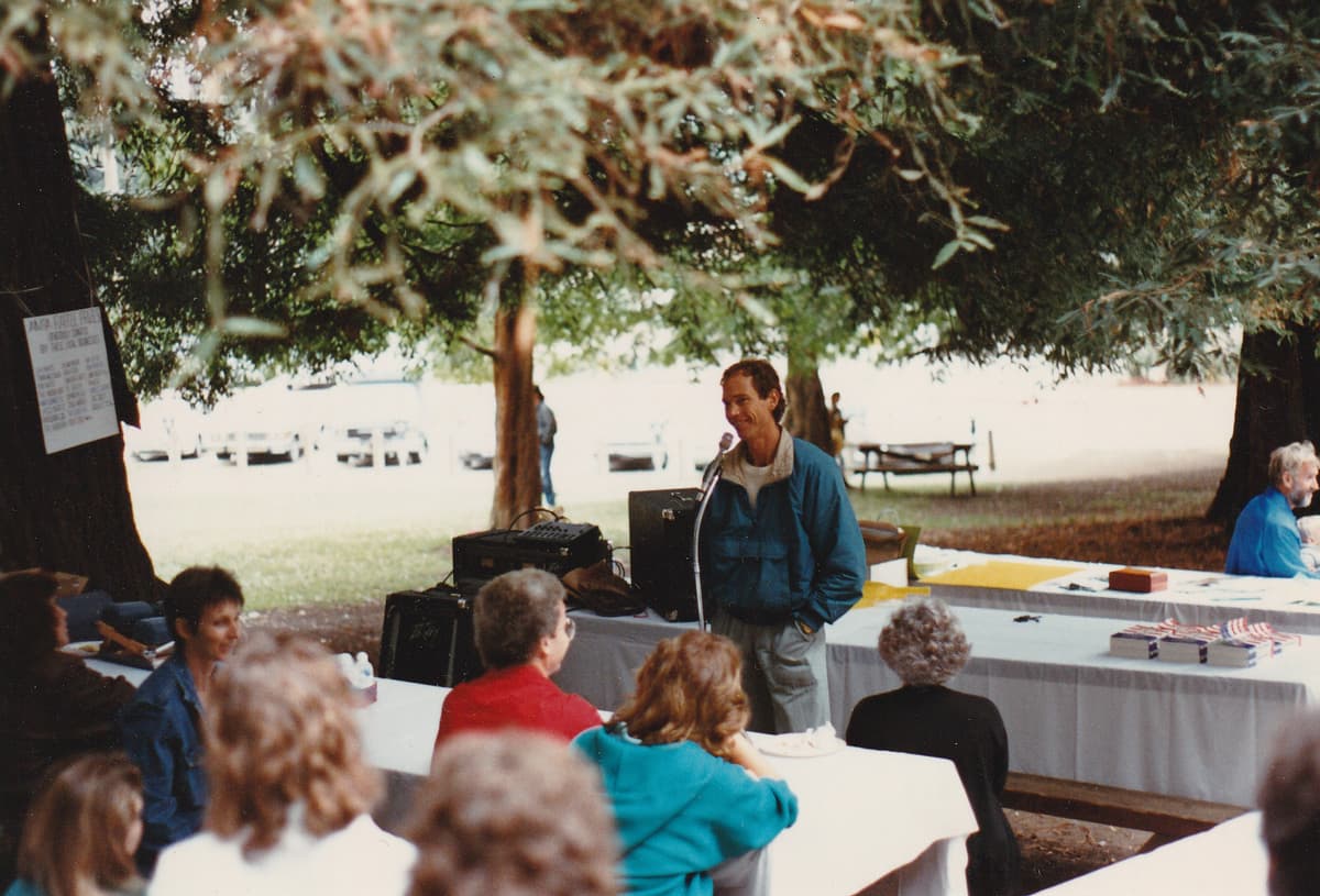 John Robbins Lecture Standing Outside blue windbreaker