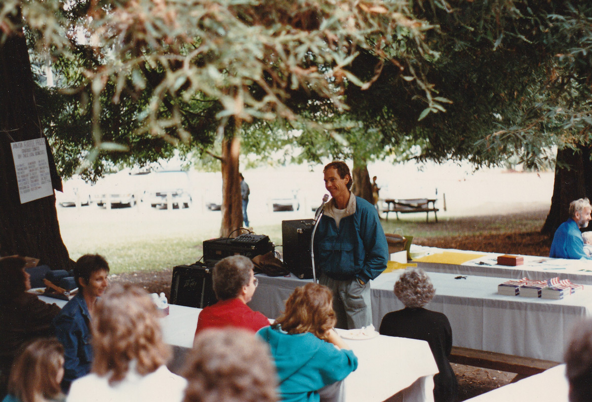 John Robbins Lecture Standing Outside blue windbreaker