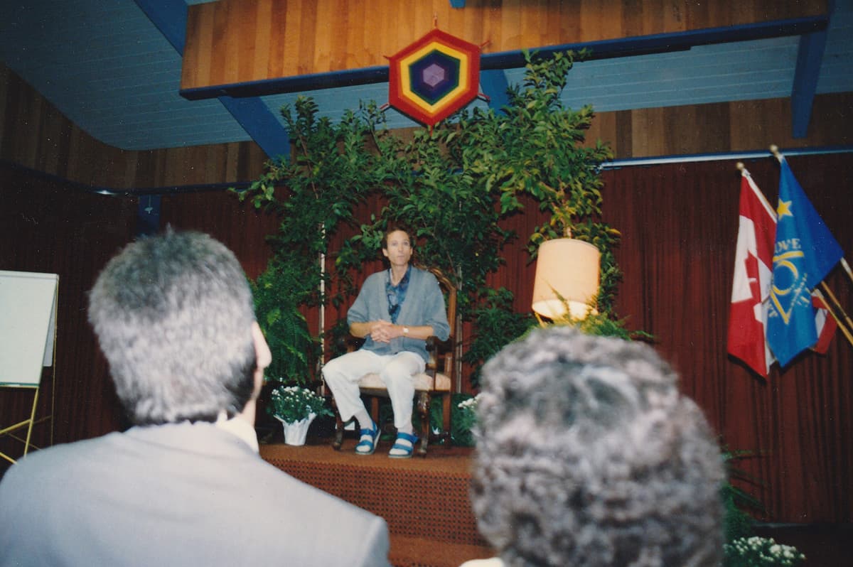 John Robbins Lecture Sitting Down sandals and blue sweater