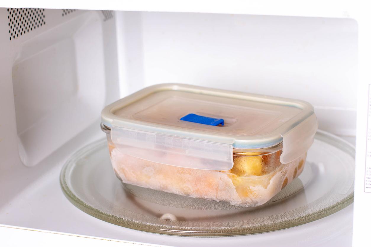 Frozen food in containers in the microwave