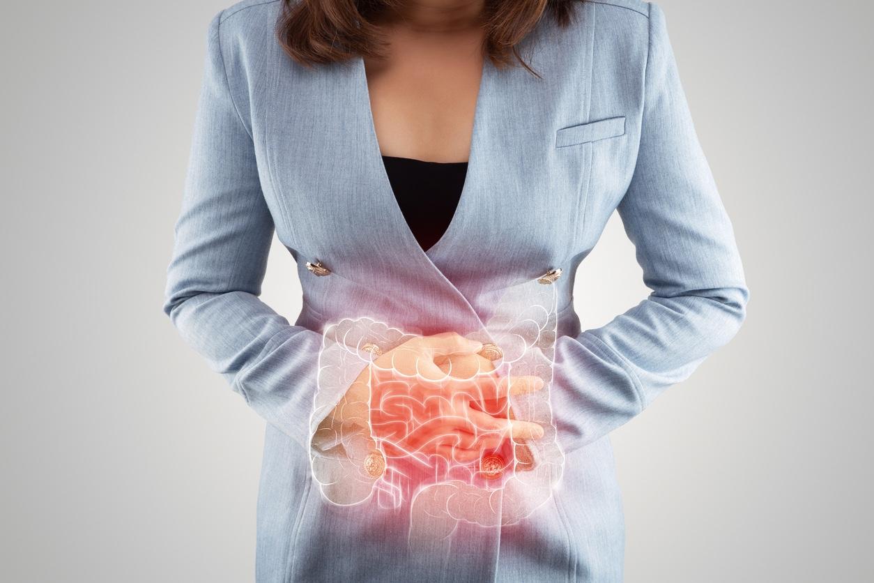 Illustration of large intestine is on the woman's body. Business Woman touching belly painful suffering from enteritis. internal organs of the human body. inflammatory bowel disease