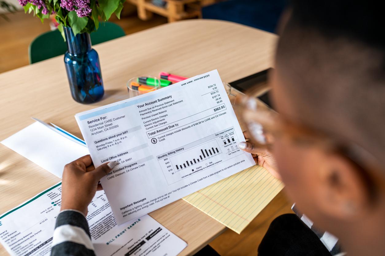 Over shoulder photo of woman looking at the bill