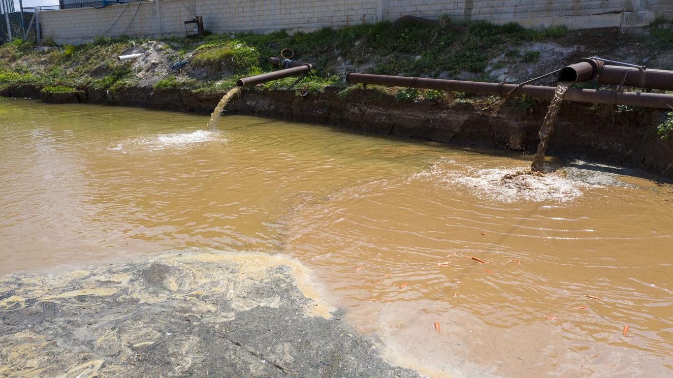 Waste water flows to river. Dirty water and environmental pollution.