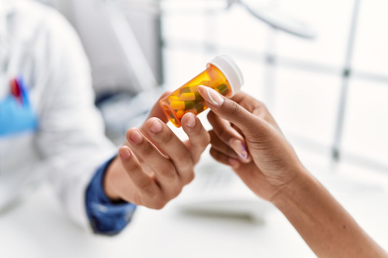 Man and woman wearing doctor uniform having medical consultation prescribe pills at clinic