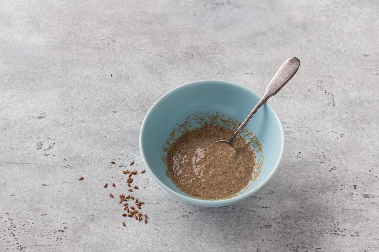 Cooking vegan flaxseed egg on gray textured background, top view