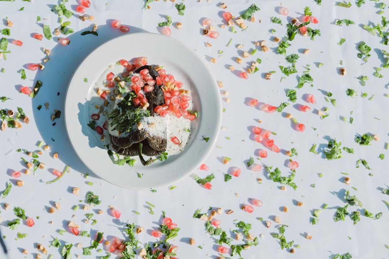 A Chiles en Nogada: A traditional Mexican dish featuring stuffed peppers with walnut sauce and fruit garnish.
