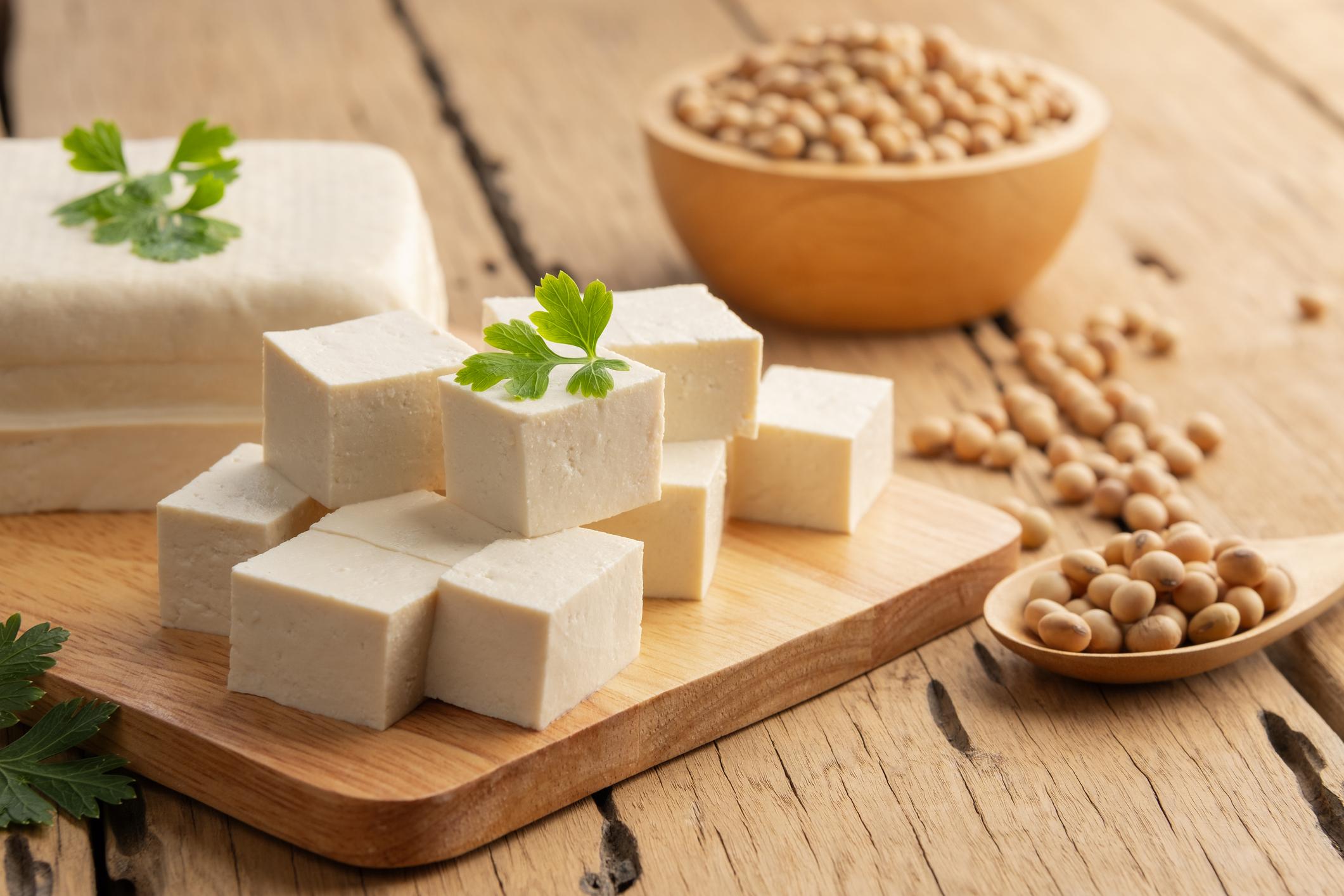 Sliced block tofu,Hard white Tofu soy bean curd on a wooden plate.