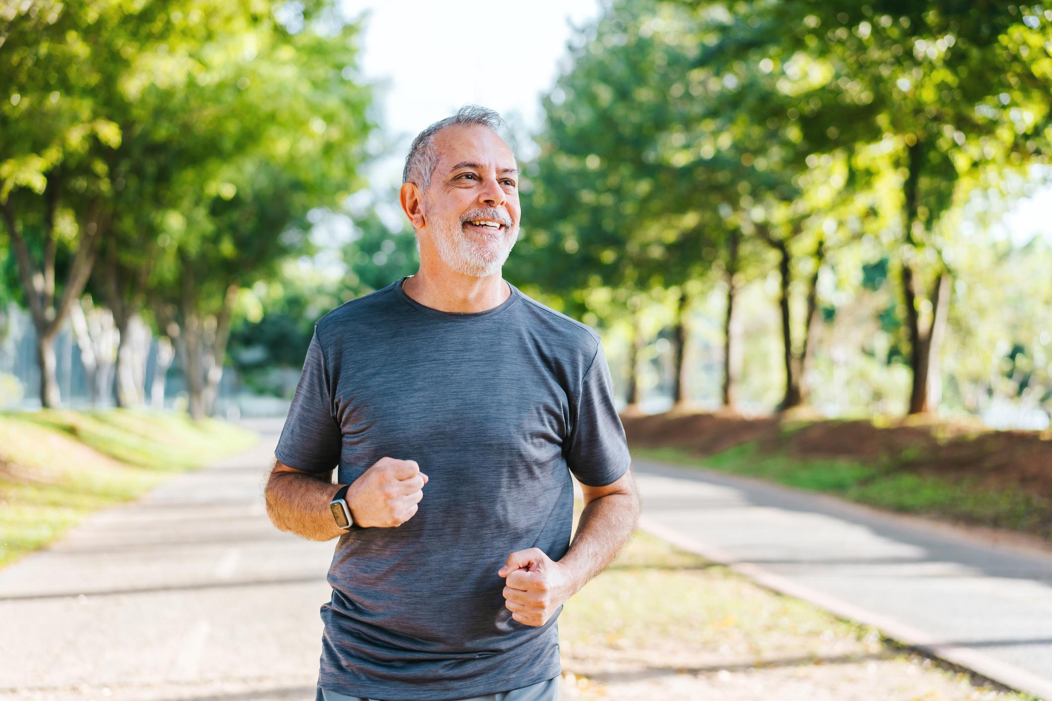 Portrait of a senior man running in the public park