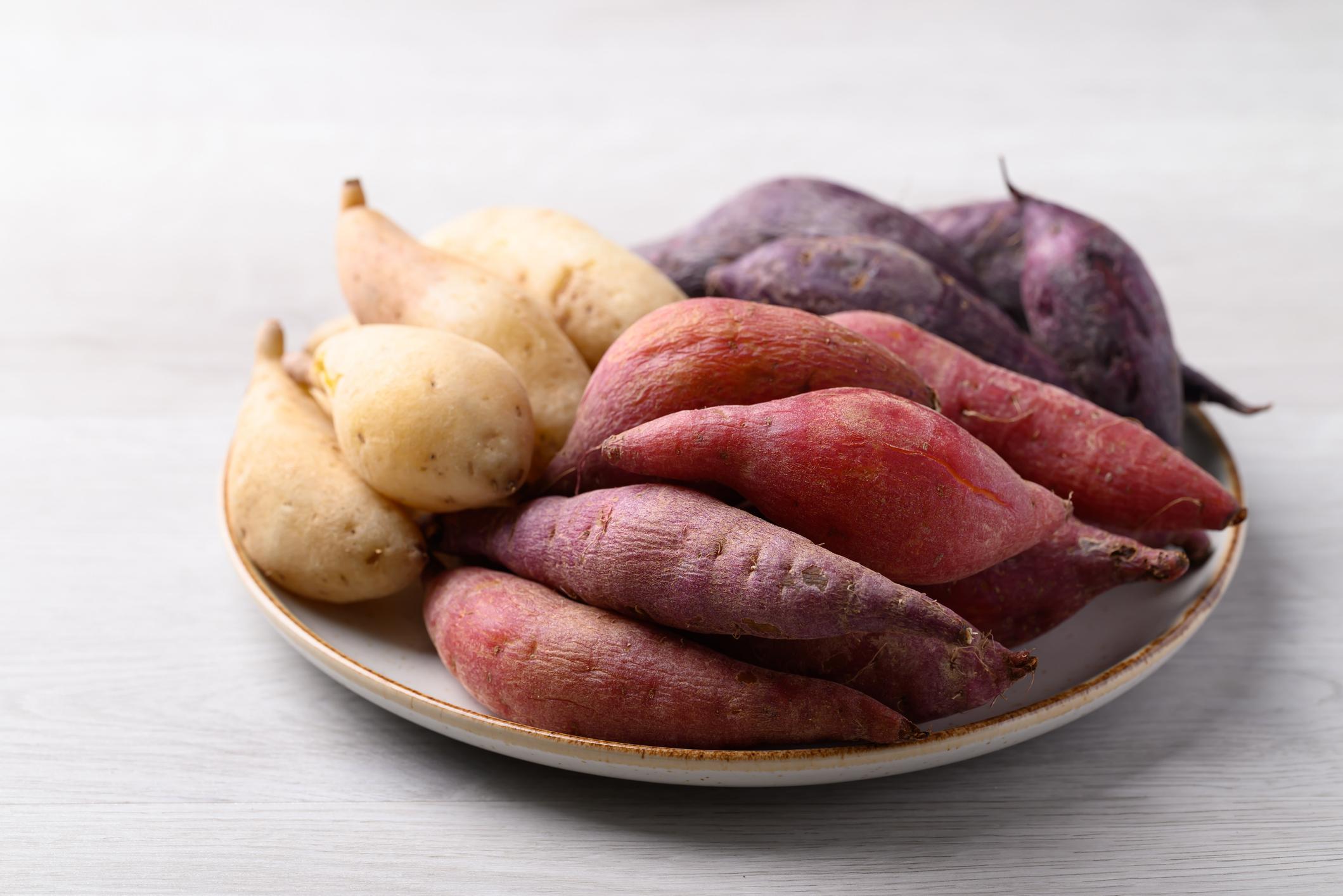 Steamed sweet potatoes on plate ready to eating on white background