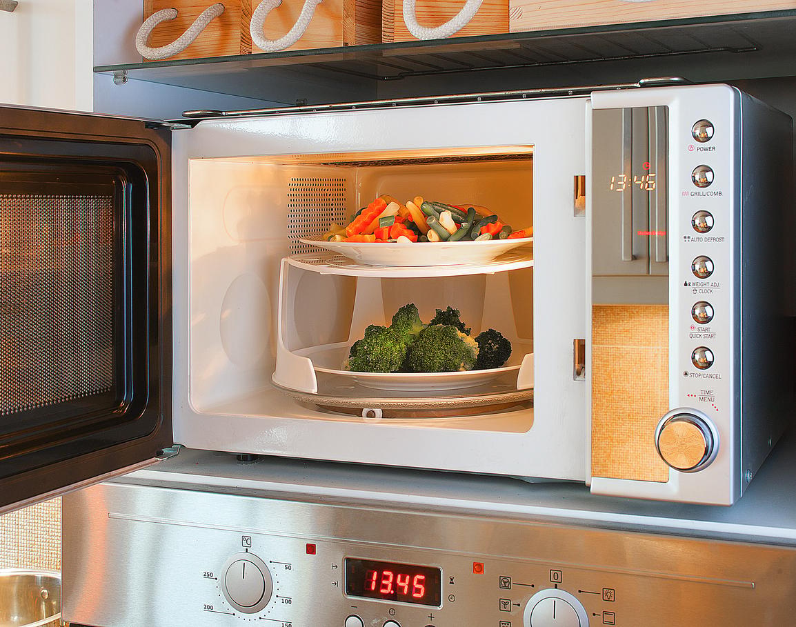 Two-tier microwave oven tray enables heating two plates at once