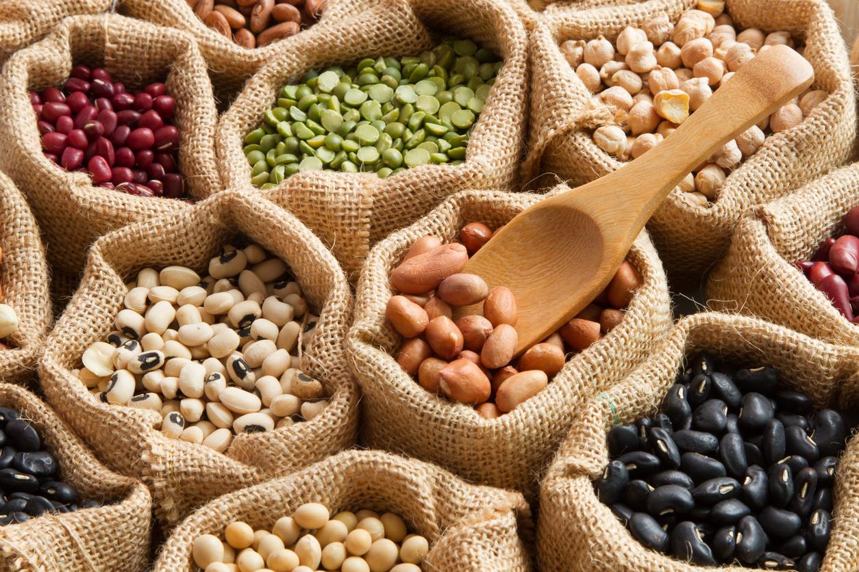 Colorful Bean seed in linen sack with wooden spoon