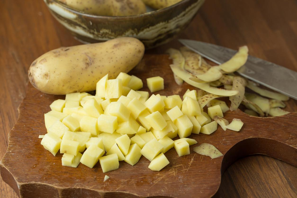 Potatoes and potato sliced on wooden table. Selective focus.
