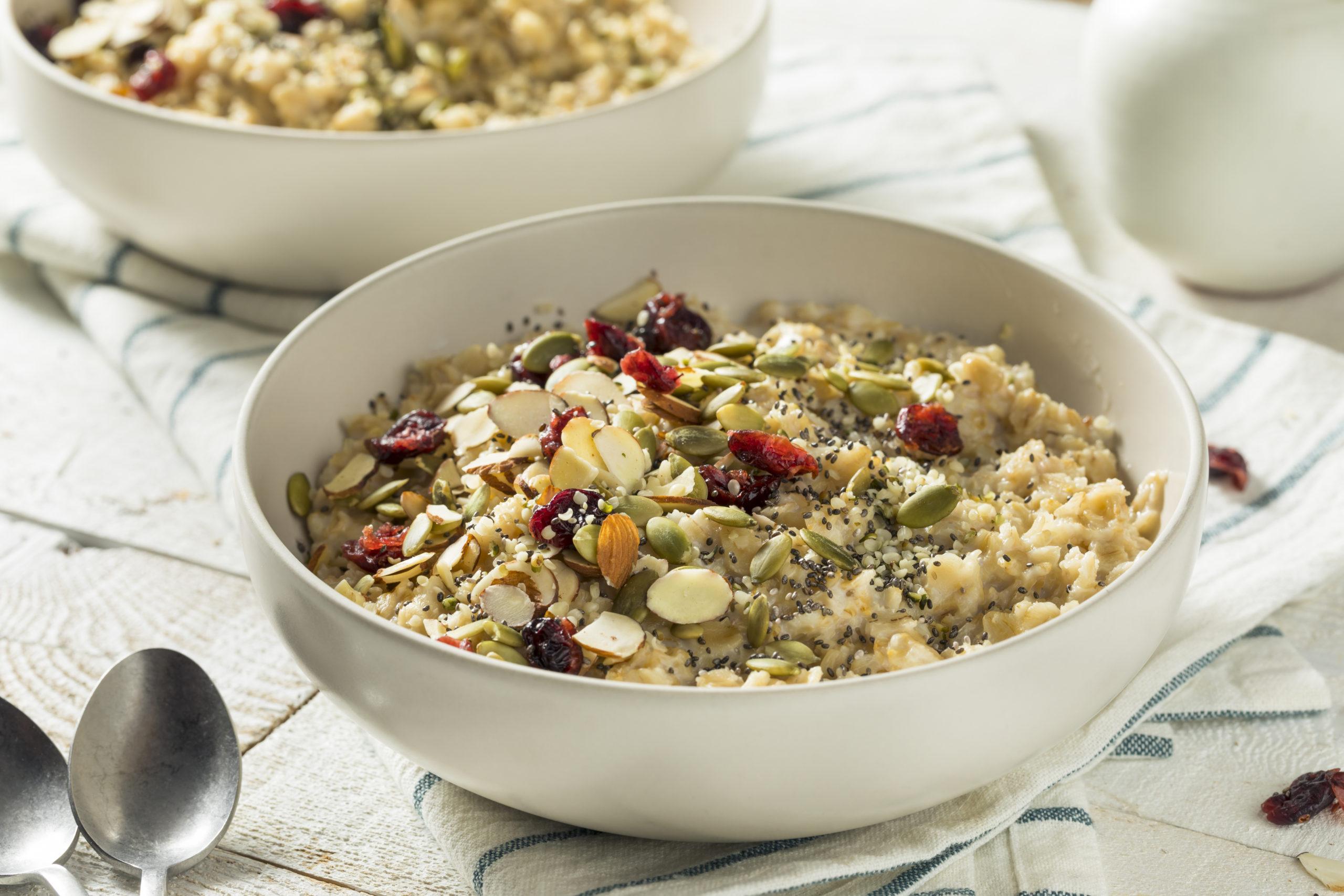 Healthy Organic Superfood Oatmeal Breakfast with Chia Seeds Pumpkin Almonds Cranberries Hemp